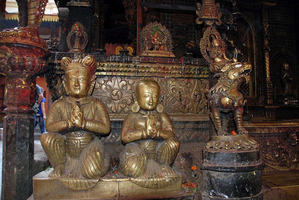 Kathmandu Patan Golden Temple 29 Statue Of King And Queen Close Up Outside Entrance Door To The Swayambhu Chaitya With A Snow Lion And Many Statues 